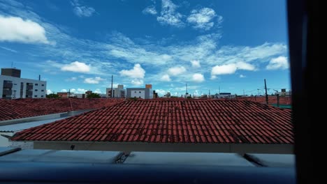 Time-lapse-from-the-window-of-a-small-apartment-looking-out-at-the-poor-community-of-Valentina-in-the-beach-capital-Joao-Pessoa-in-Paraiba,-Brazil-on-a-warm-sunny-summer-day