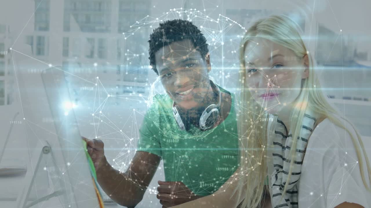 Man guiding woman, tapping screen and activating holo globe, both smiling at camera in tech lab