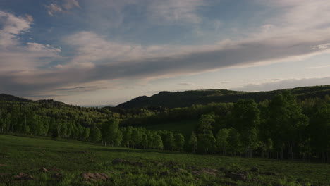 time-lapse of clouds rolling over lush nature landscape.