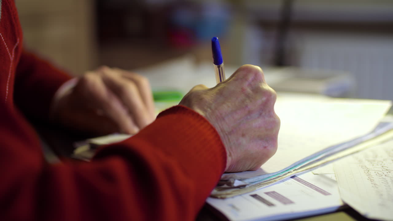 Senior Businessman Writing On Paper At Table In Office 35