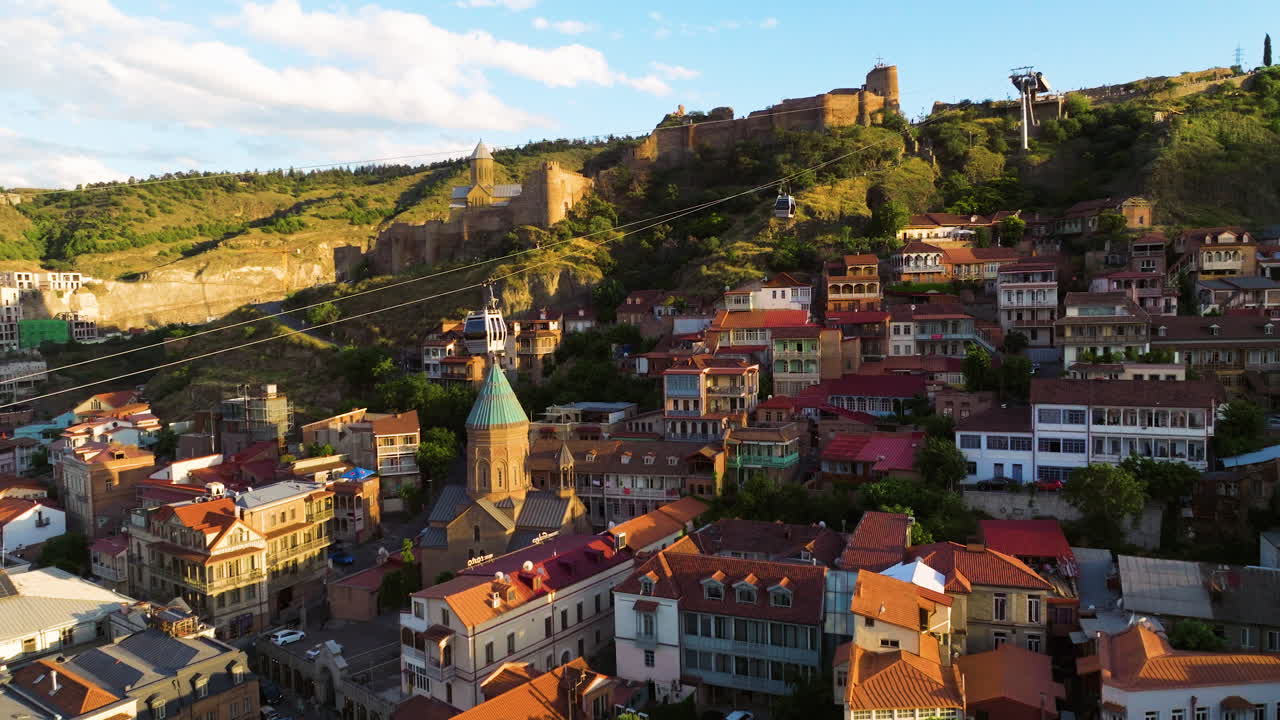 Aerial Approaching Cable Car Cabins Over City Skyline During Sunset In Tbilisi, Georgia.