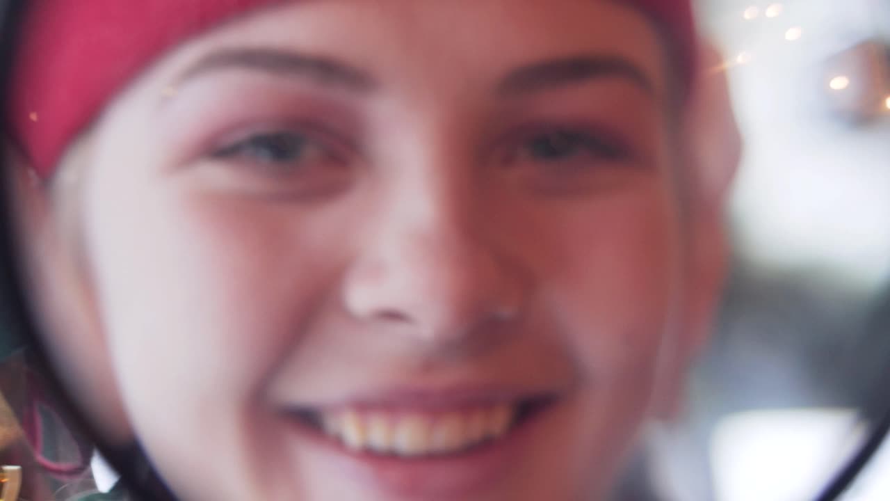 Cheerful elf girl looking at the camera through a magnifying glass. close-up