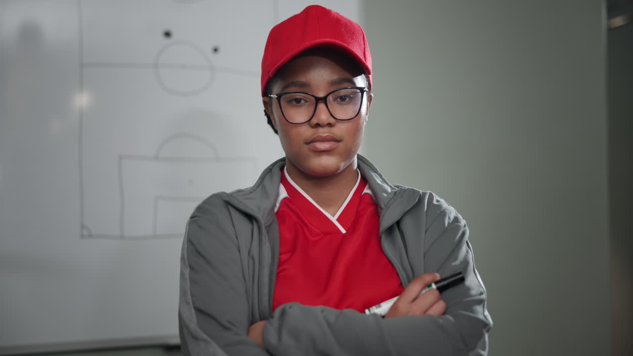 A woman coaching with a whiteboard behind
