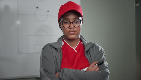 a woman coaching with a whiteboard behind
