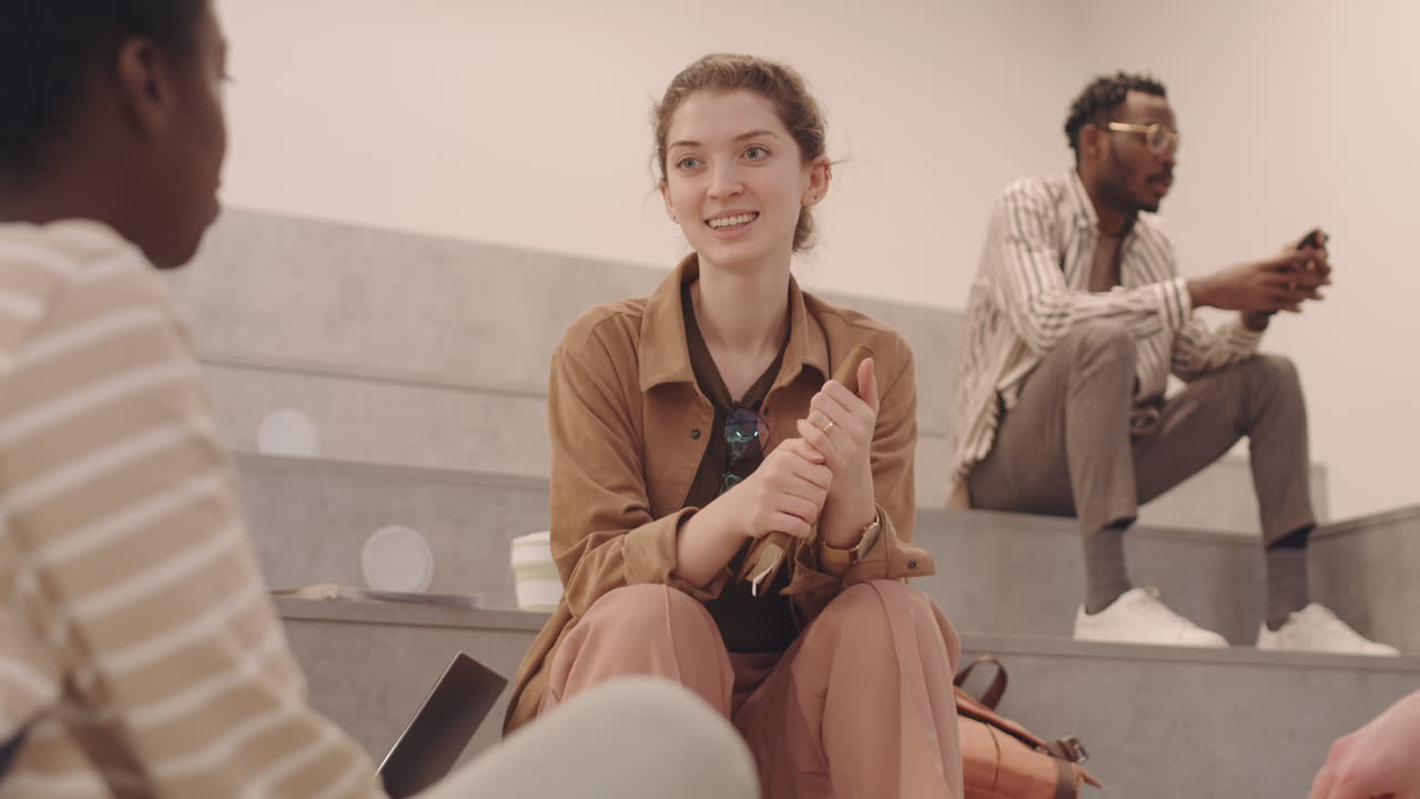 Female Student Talking to Classmates at Break