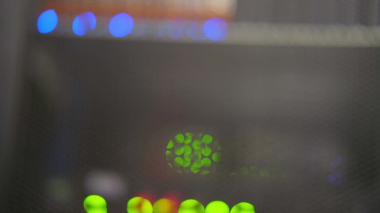 Blurred background of LED lights of server telecommunications equipment, abstract close-up