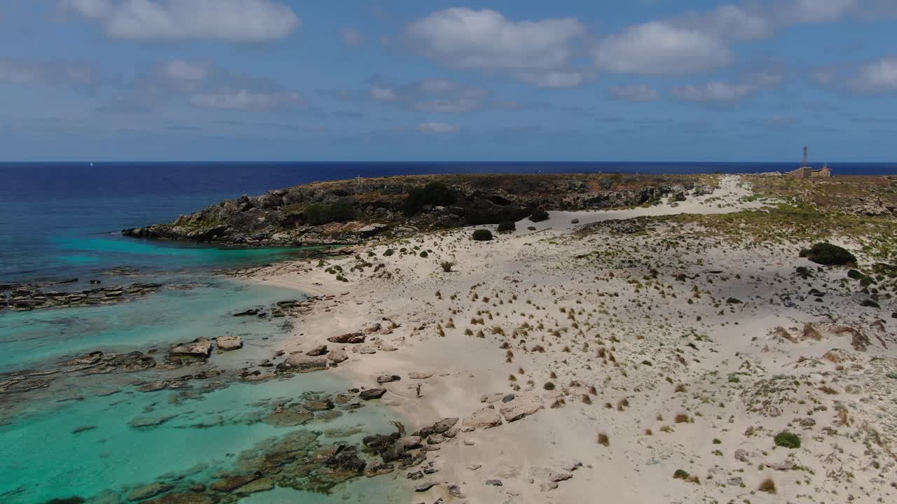 Elafonissi peninsula in Crete Greece with Church of Agia Irini right and Cave of memory left side, Aerial dolly in shot