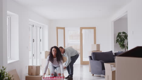 loving couple surrounded by boxes hug as they move into new home together