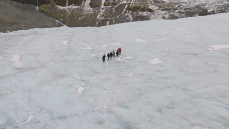 aerial view of people hiking on the ice surface of virkisjokull glacier, iceland