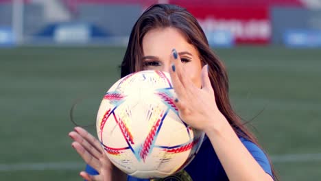 cute brazil fan plays with football in stadium, slow motion