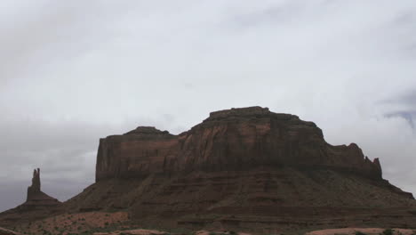 clouds pass over a mesa in the desert