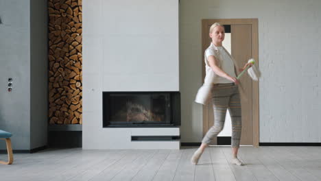 woman cleaning and dancing in a modern living room