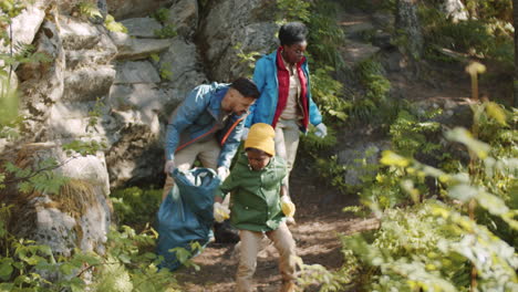 family cleaning camp area before leaving