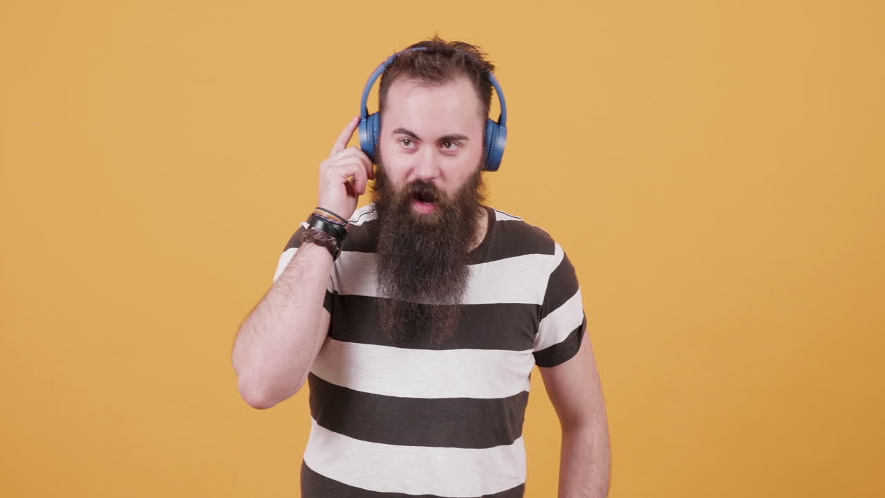 Man with beard and headphones listening to music