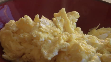 a slow move into a bowl of steaming scrambled eggs