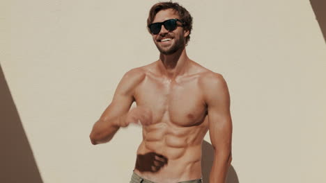 smiling muscular man in sunglasses