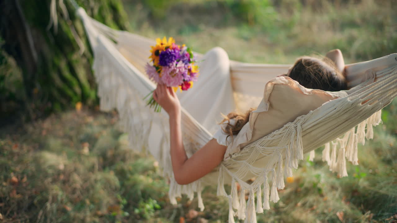 Girl in hammock surrounded by sunset magic