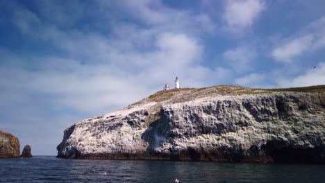 gimbal tilting down shot from a moving boat of the anacapa island lighthouse on east anacapa island, part of channel islands national park off the coast of california