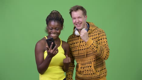 young multi-ethnic couple using phone together