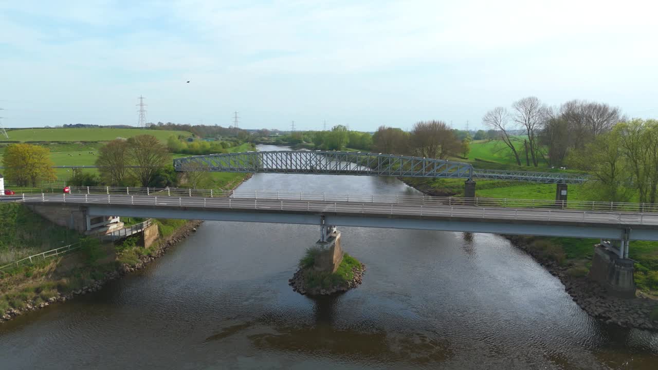 Rural England River Crossing Captured by Aerial Drone, Highlighting Infrastructure, Green Fields, and Serene Countryside Views