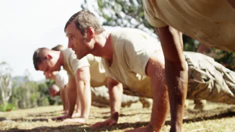 military soldiers dosing push-ups during obstacle course 4k