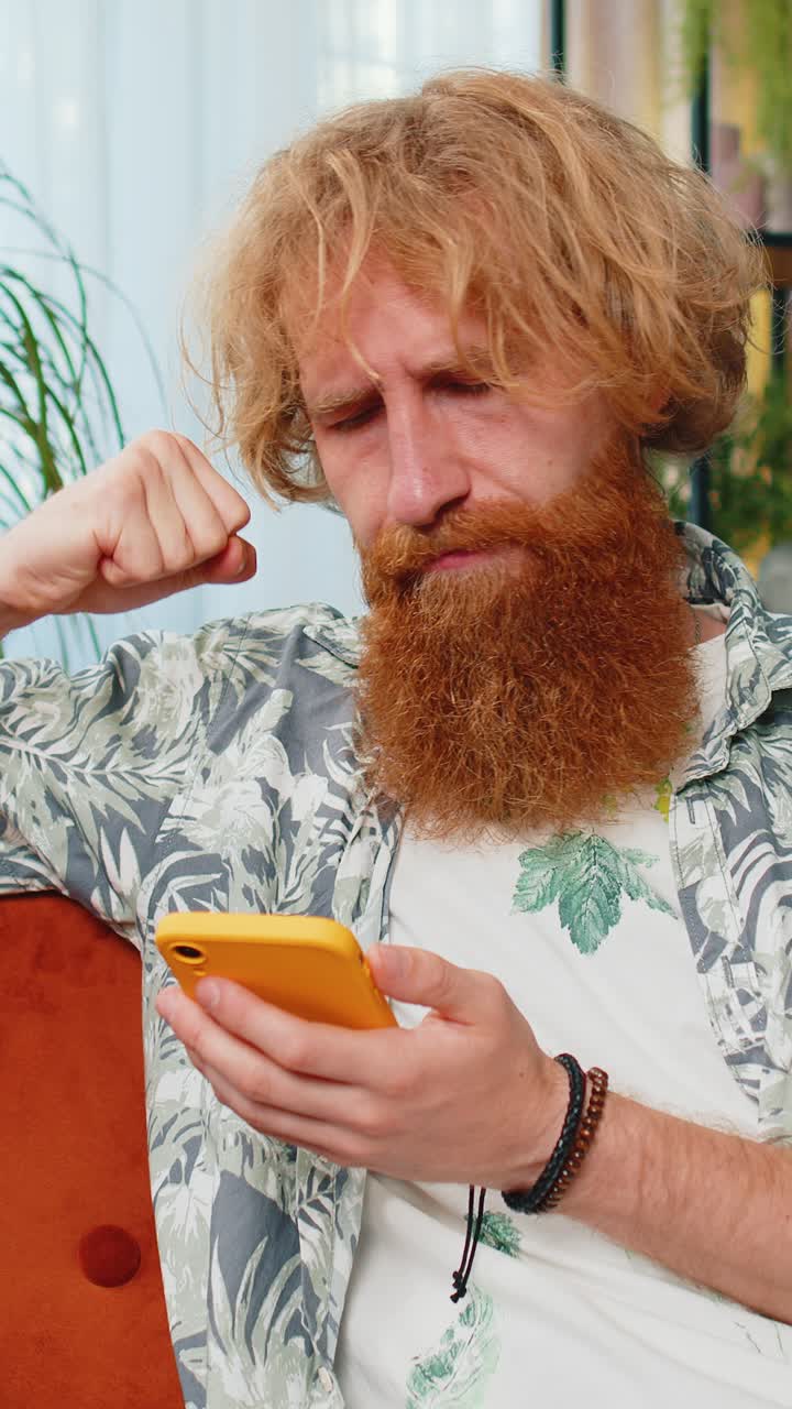Sad young man use smartphone surprised by bad news fortune loss fail lottery results deadline