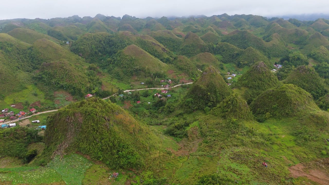 High-angle perspective of the iconic cone-shaped hills of Osmeña Peak, showcasing the dramatic mountain landscape of Cebu