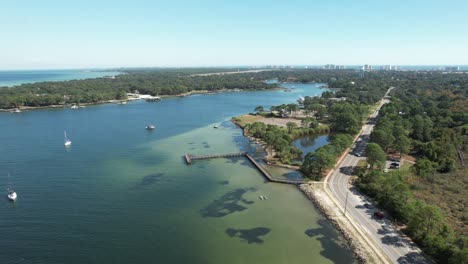 destin, florida, united states - a sweeping landscape of a bay enveloped in verdant surroundings - aerial panning