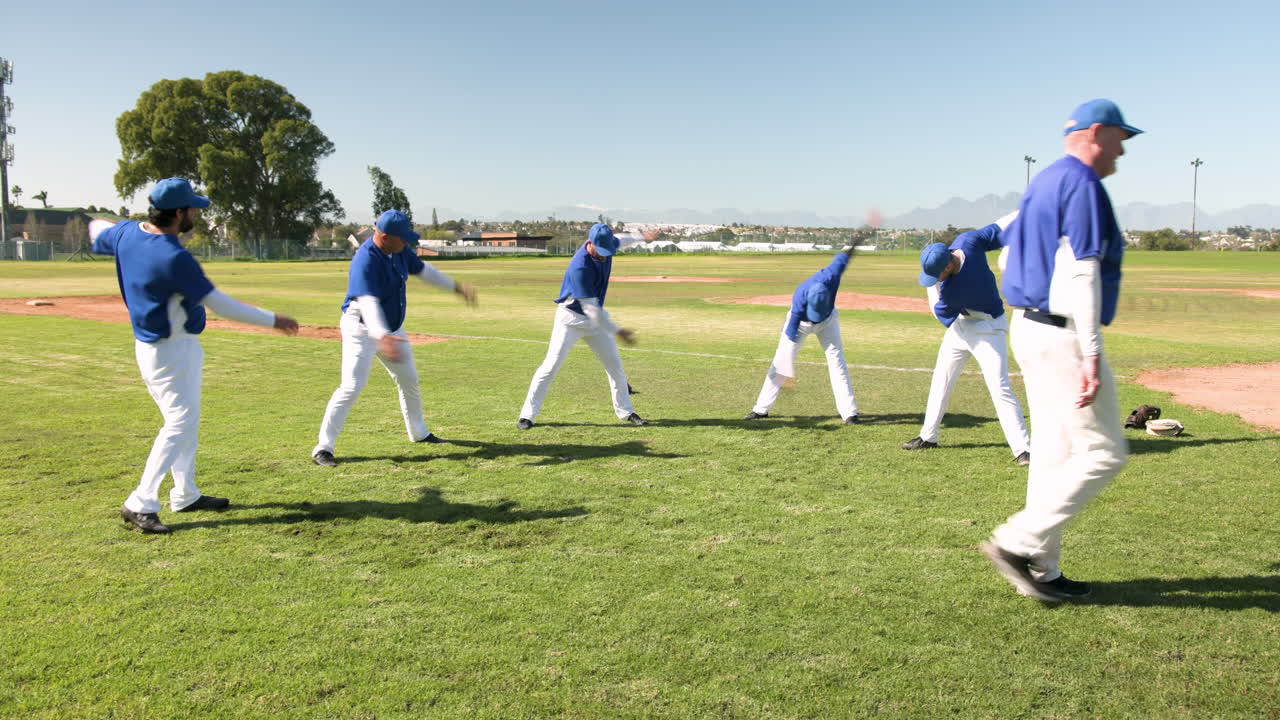 Baseball players stretching and warming up on field during practice session