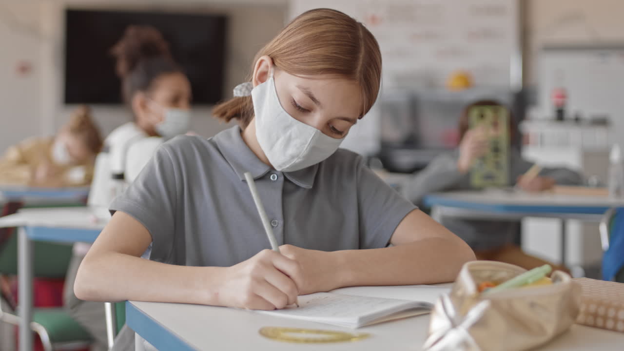 School Girl in Face Mask Sneezing in Class