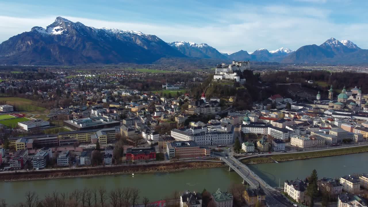 Aerial view of Salzburg City, Salzburg Fortress and snow-brushed Alps in the background, Austria