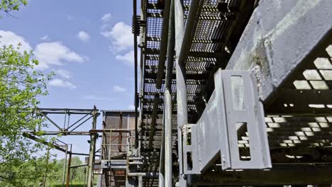 rusty-grating-metal-steps-abandoned-in-nature-on-an-old-industrial-site-of-the-landscape-park-duisburg-north-germany