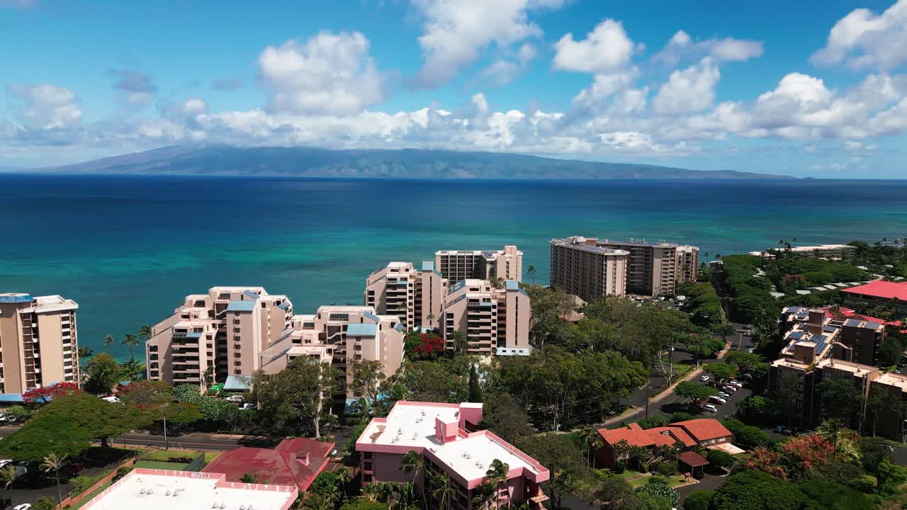 Aerial View of Coastal Resorts and Ocean with Distant Island in Maui, Hawaii