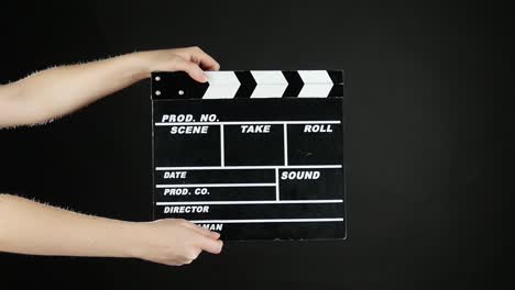 Clapperboard held by hands
