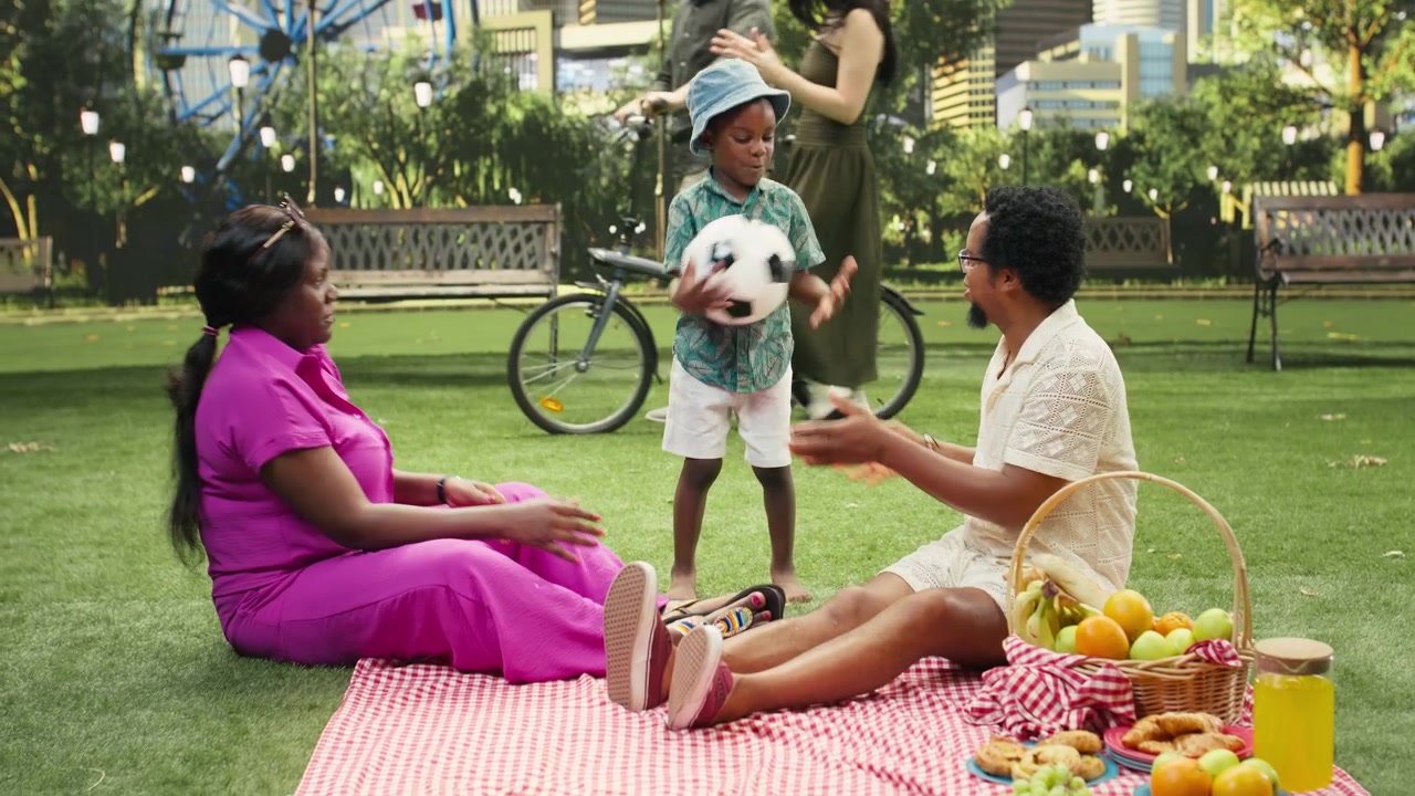 Young boy jumping and laughing while throwing ball at parents
