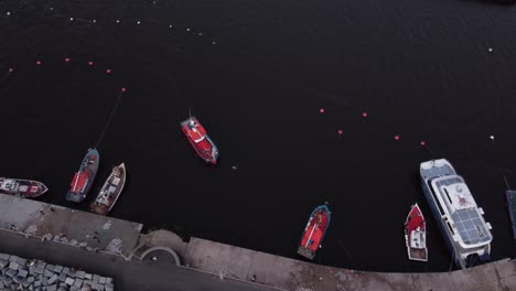 fishing boat arriving to harbor dock top down aerial drone view, punta del este in uruguay