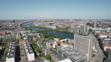 Capture-Copenhagen-from-a-bird's-eye-perspective-with-an-aerial-view-of-its-stunning-lakes,-revealing-the-city's-vibrant-center-and-office-buildings