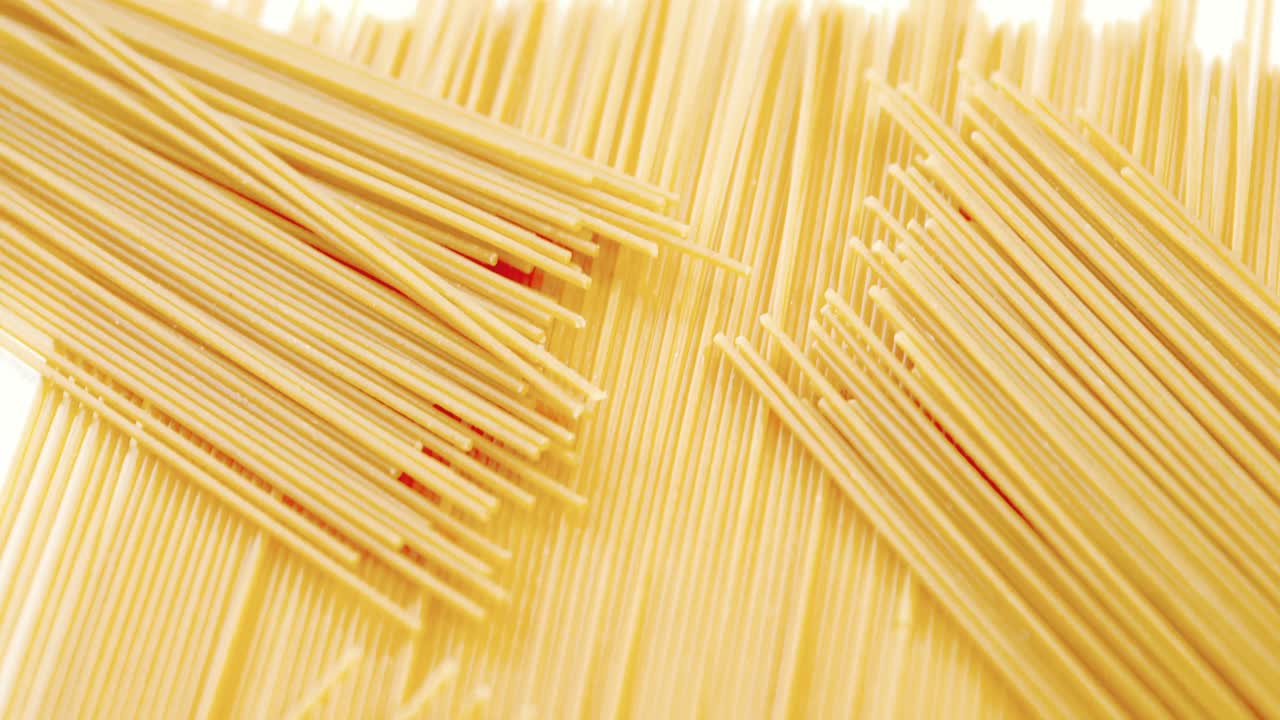 Raw spaghetti on white background
