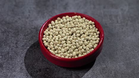 white pepper is placed on a bowl