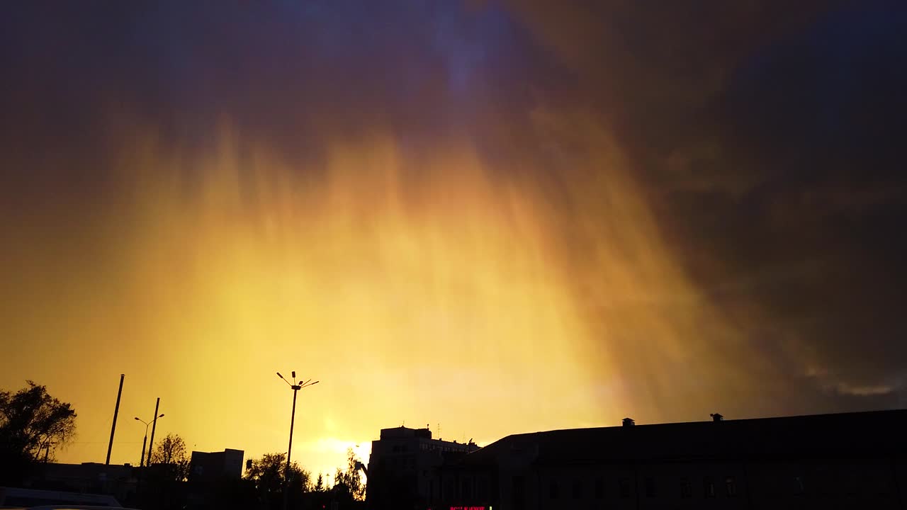 Rain clouds with beautiful sunshine over the city of Kazan, Russia. Static shot.