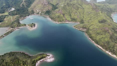 hong kong island landscape with green hills, unique sand strips and hidden bays, aerial view