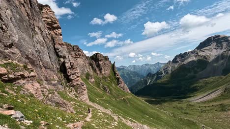 jagged rocky ridge and vast alpine valley beneath a bright blue sky in the alpe devero region, italian alps