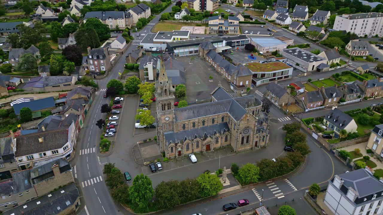 Sideways drone movement near the historic monument of Saint-Sauveur Church of Plancoet, Côtes-d'Armor, Brittany, France.