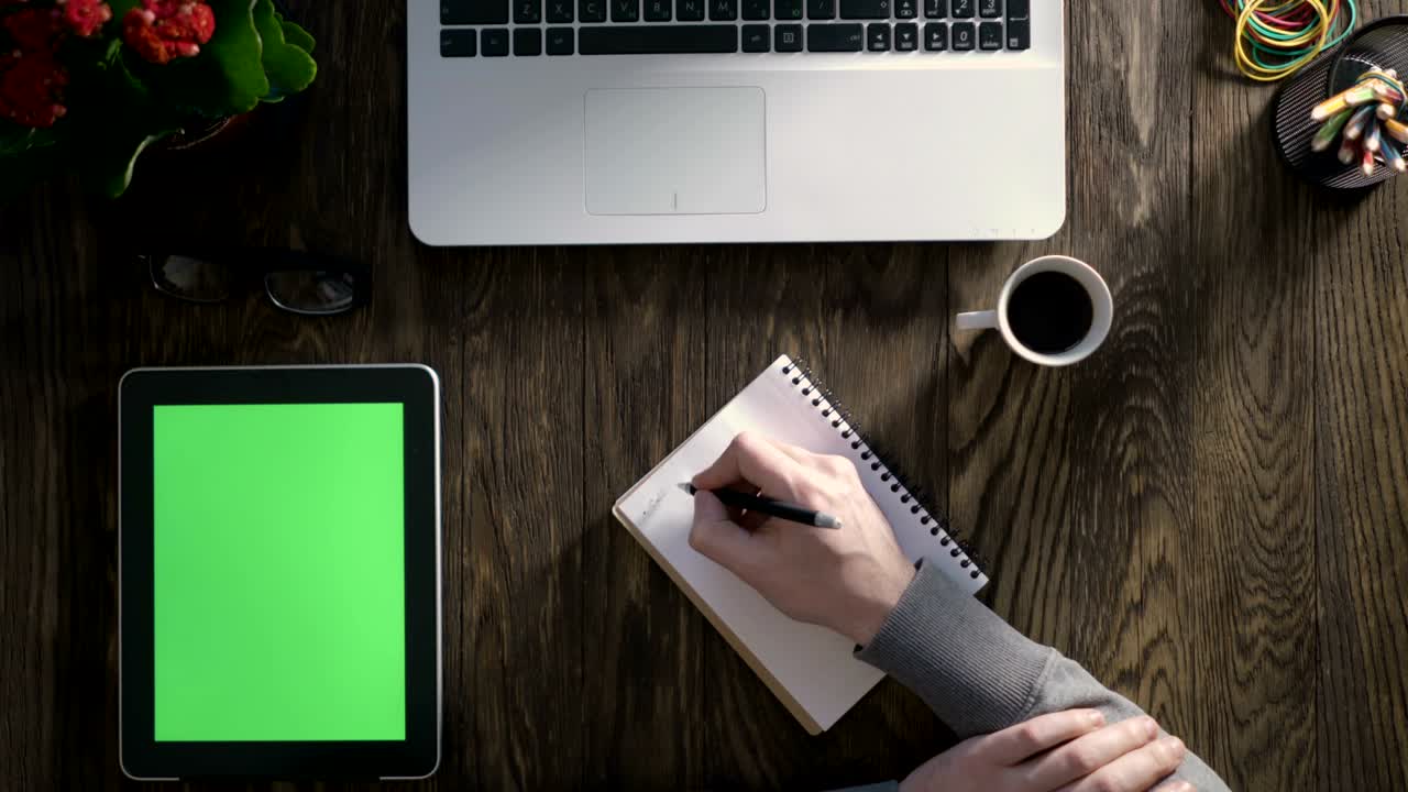 Top view of wooden table with office supplies.