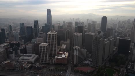 aerial view of the san francisco cityscape with hazy sunset sky - approaching, drone shot