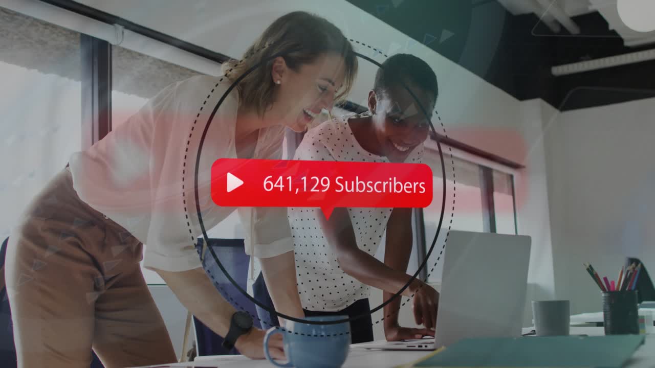 Marketing team leaning on laptop reviewing as subscriber overlay climbing onscreen tracking growth