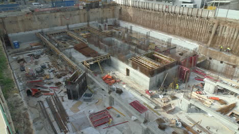 aerial dolly shot of a construction site foundations with building materials