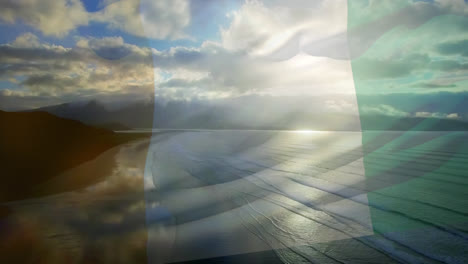 composición digital de la bandera de costa de marfil ondeando contra la vista aérea de las olas en el mar