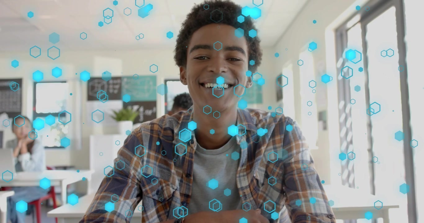 Teen male student leaning in writing with yellow pencil as floating hexagons visualizing education