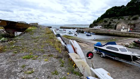 boats docked along a stone path